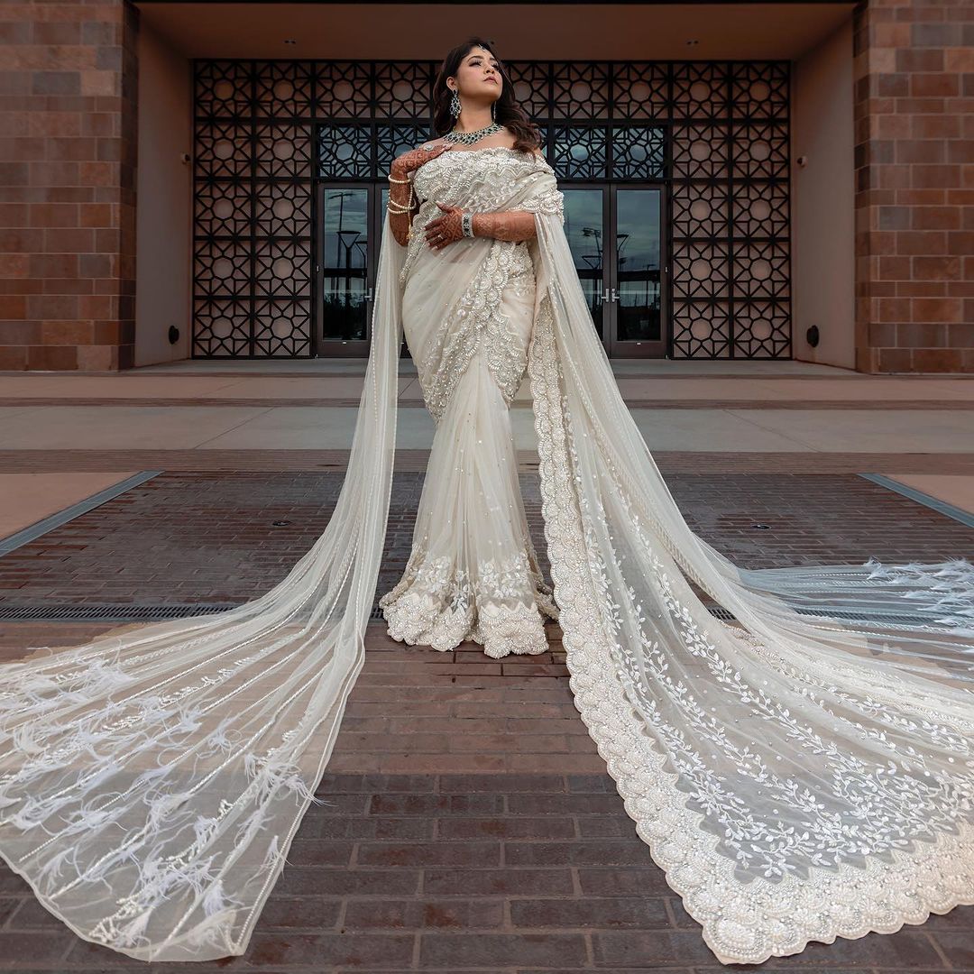 PEARL WHITE COLOR SAREE WITH FAIRY LONG TRAIL
