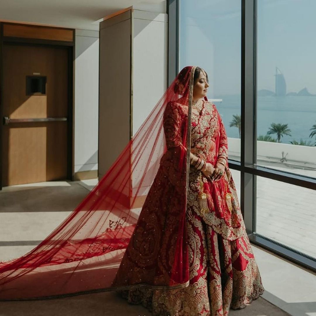 CARDINAL RED BRIDAL LEHENGA WITH GRACEFUL TRAIL